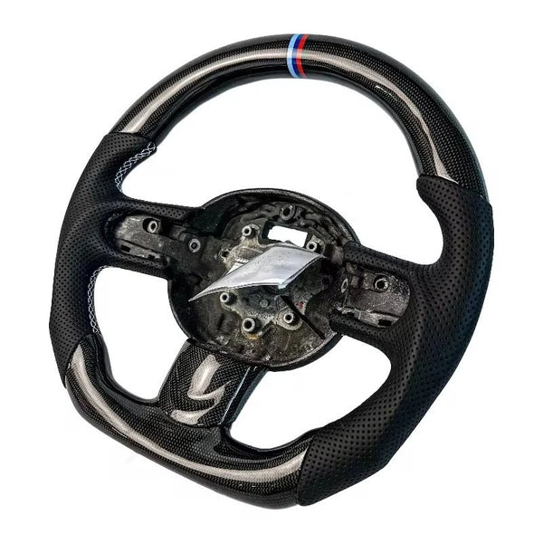 MINI Cooper carbon fibre steering wheel front-on with tricolour stripe at the top and perforated leather grips